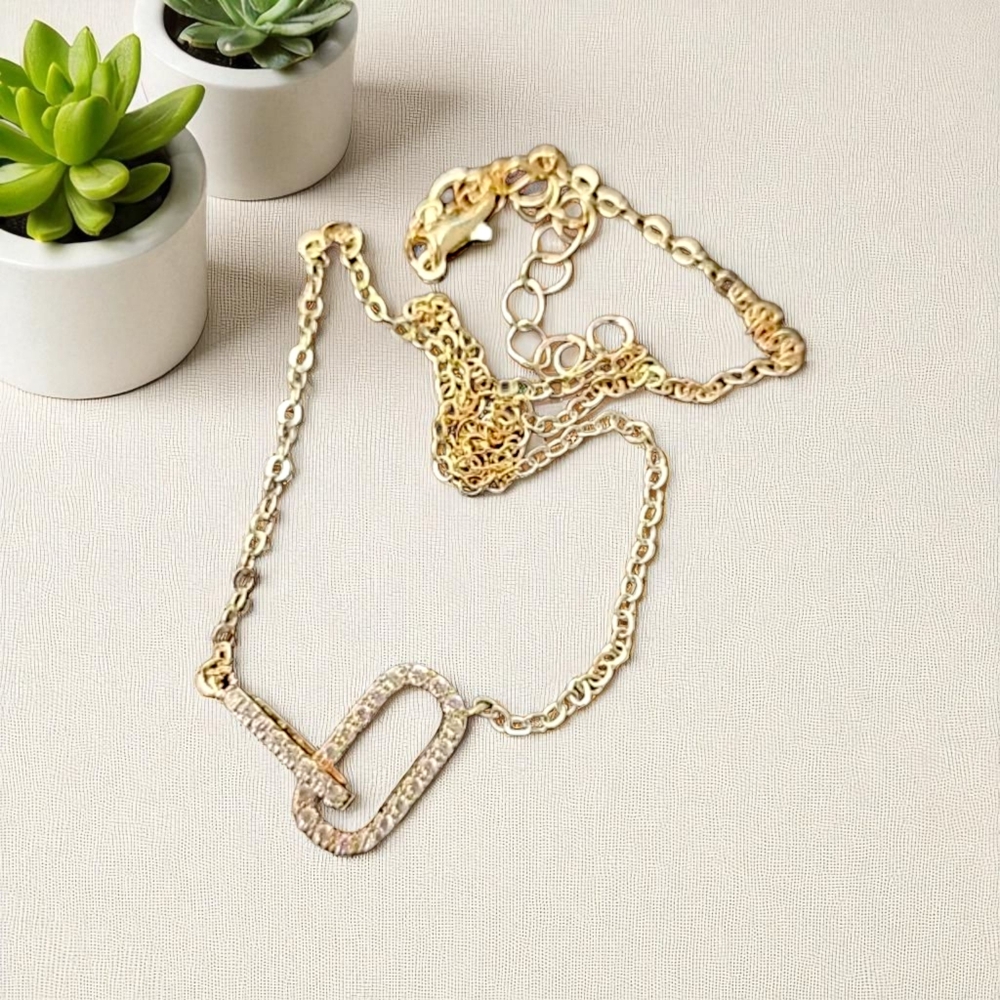 Gold tone necklace with double interlocking zirconia rectangler; nwot